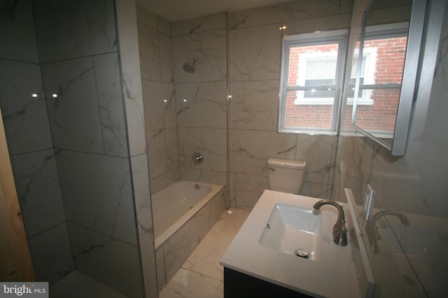 full bathroom with vanity, toilet, and tiled shower / bath combo