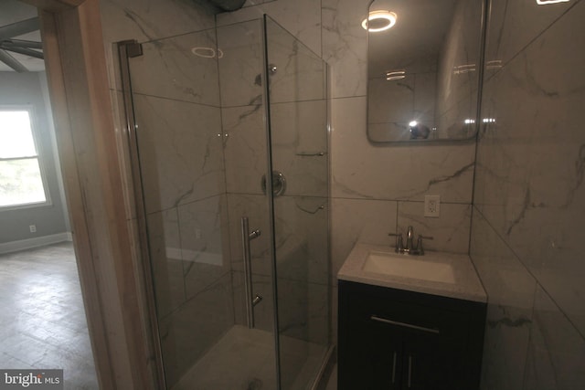 bathroom with tasteful backsplash, vanity, and an enclosed shower