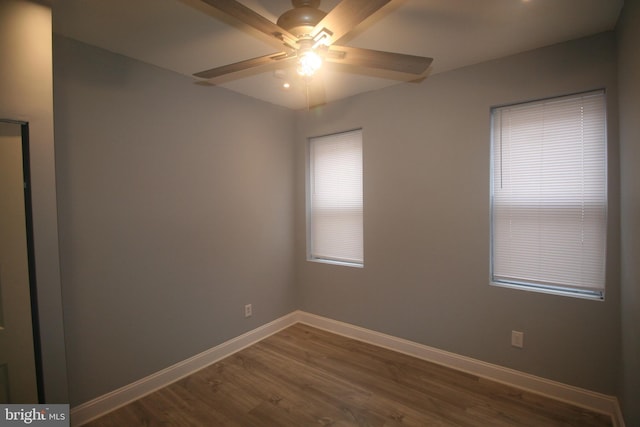 empty room featuring ceiling fan and dark wood-type flooring