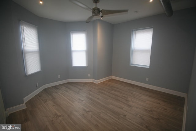 unfurnished room featuring ceiling fan and dark wood-type flooring