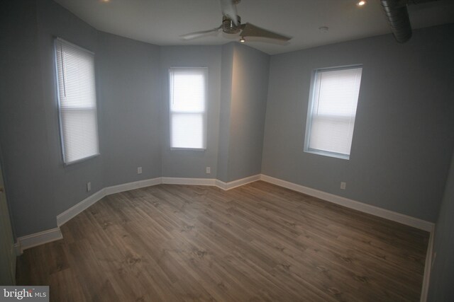 unfurnished room featuring dark hardwood / wood-style flooring and ceiling fan