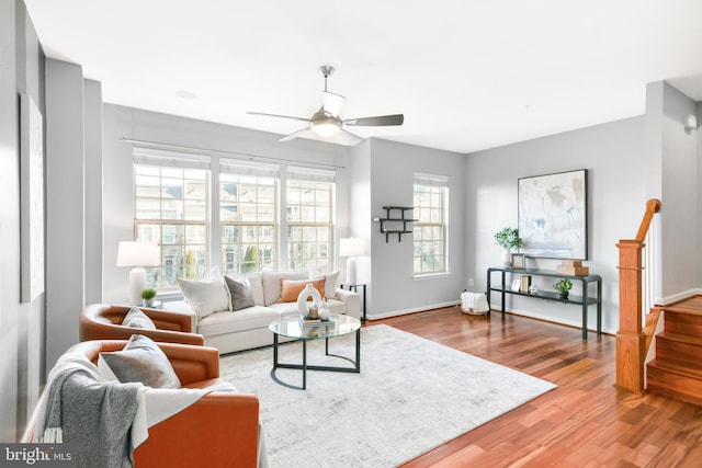 living room with hardwood / wood-style flooring and ceiling fan