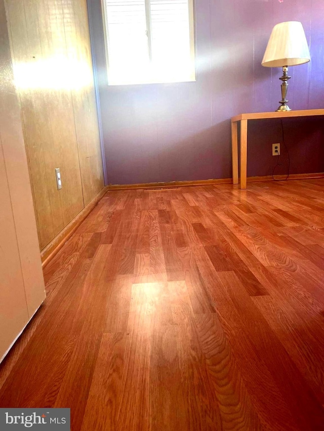 unfurnished room featuring hardwood / wood-style floors