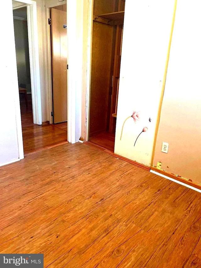 unfurnished bedroom with hardwood / wood-style flooring