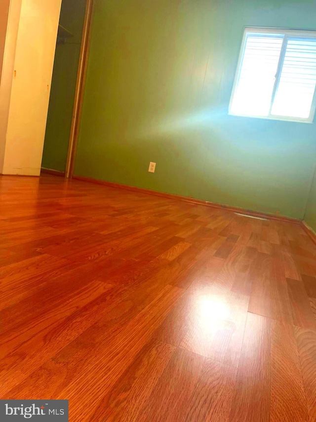 empty room with hardwood / wood-style flooring