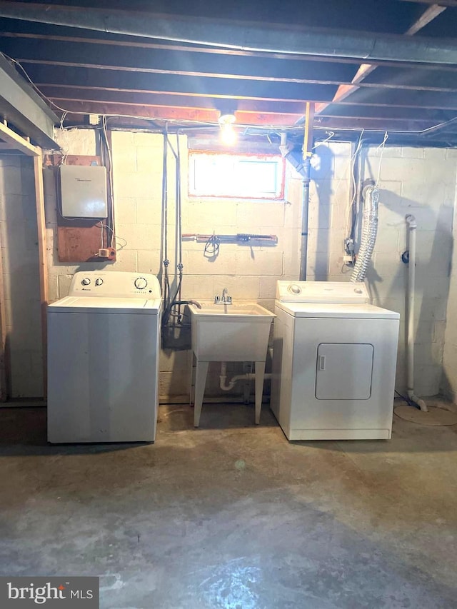 basement featuring sink and washer and dryer