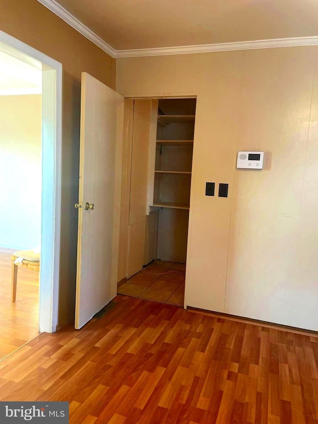 corridor featuring hardwood / wood-style flooring and crown molding