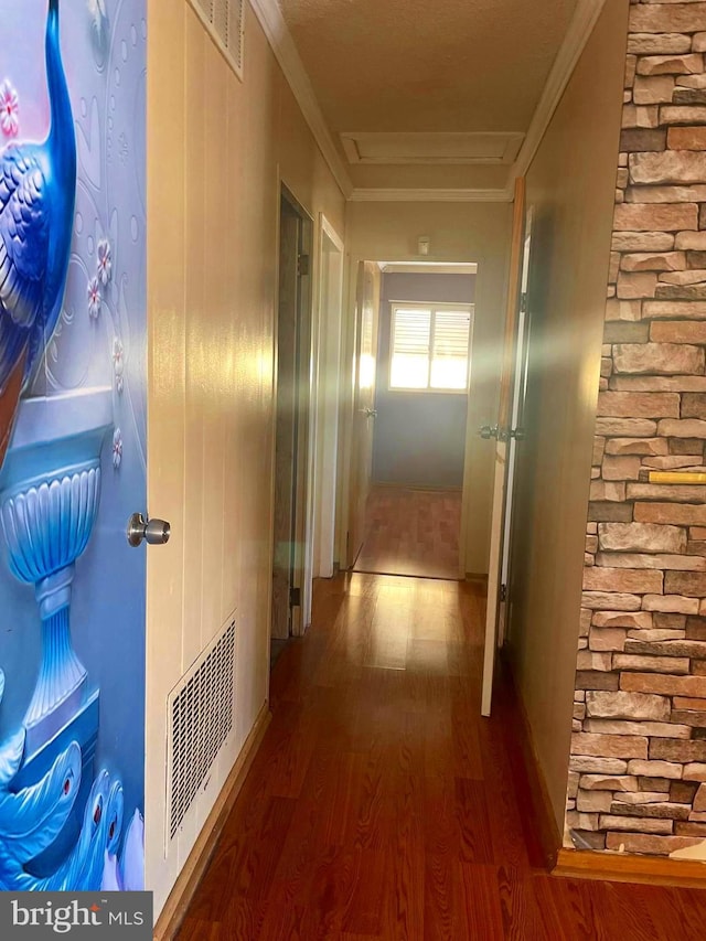 corridor with wood-type flooring and ornamental molding