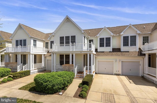 multi unit property with a balcony, a porch, and a garage