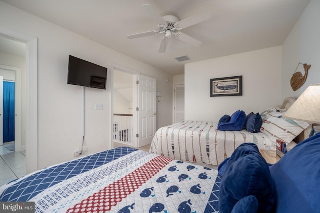 tiled bedroom with ceiling fan