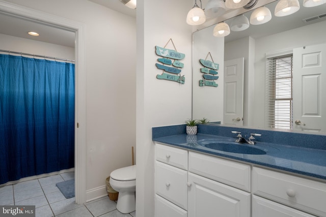 bathroom featuring tile patterned floors, vanity, and toilet