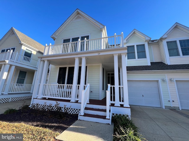 view of front facade with a porch, a garage, and a balcony