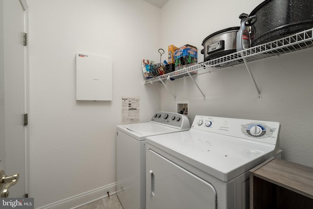 laundry area with washing machine and dryer and light tile patterned flooring