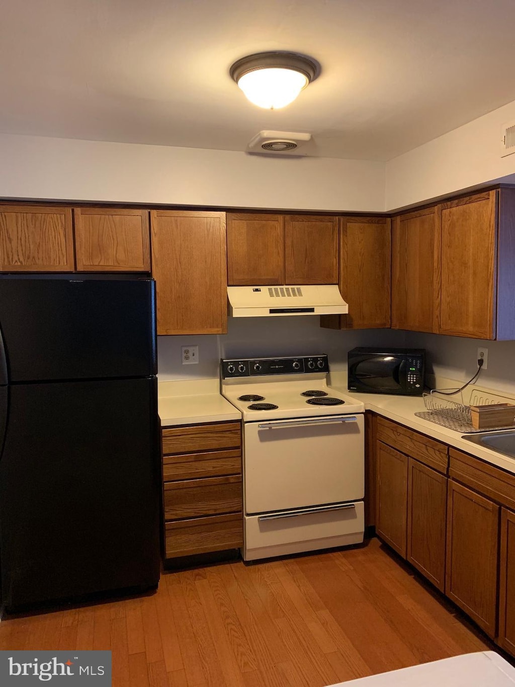 kitchen featuring black appliances and light wood-type flooring