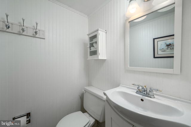 bathroom featuring ornamental molding, vanity, and toilet