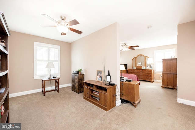 interior space featuring light carpet and ceiling fan