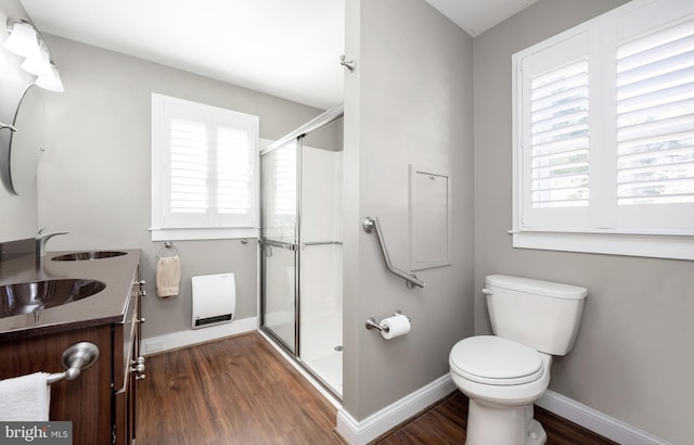 bathroom with vanity, hardwood / wood-style flooring, toilet, and a shower with shower door