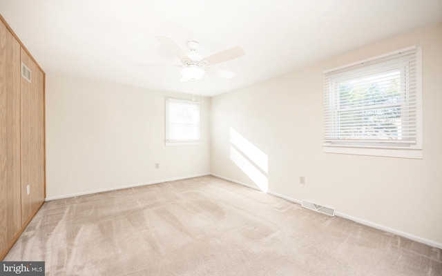 unfurnished bedroom with ceiling fan and light carpet