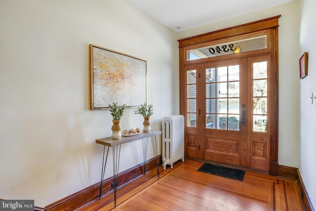 doorway featuring radiator and wood-type flooring