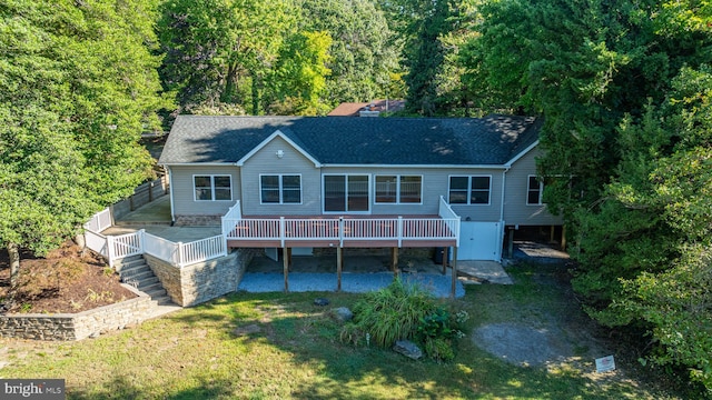 back of house featuring a yard and a deck