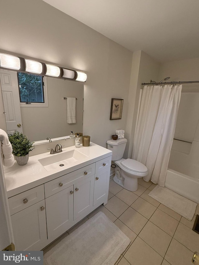 full bathroom featuring shower / bath combo with shower curtain, tile patterned flooring, vanity, and toilet