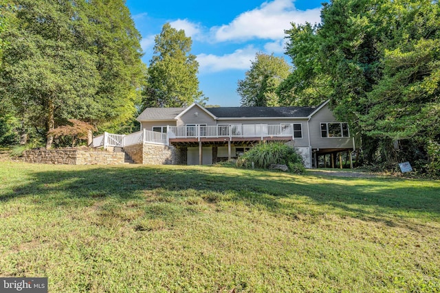 rear view of property with a yard and a deck