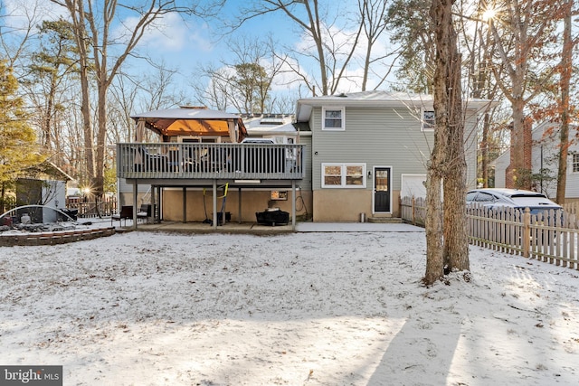 snow covered property with a deck