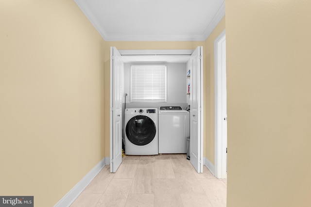 laundry room featuring crown molding and washer and clothes dryer