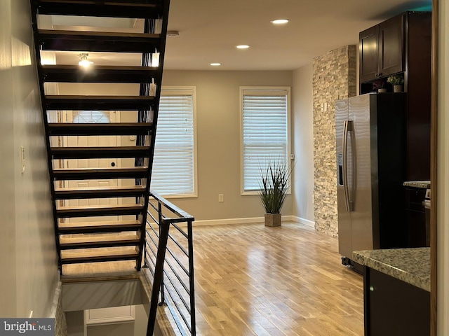 stairs featuring hardwood / wood-style flooring