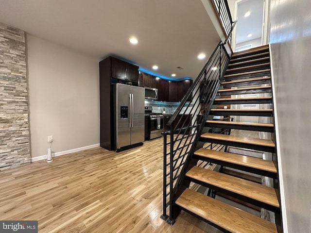 stairs featuring hardwood / wood-style flooring