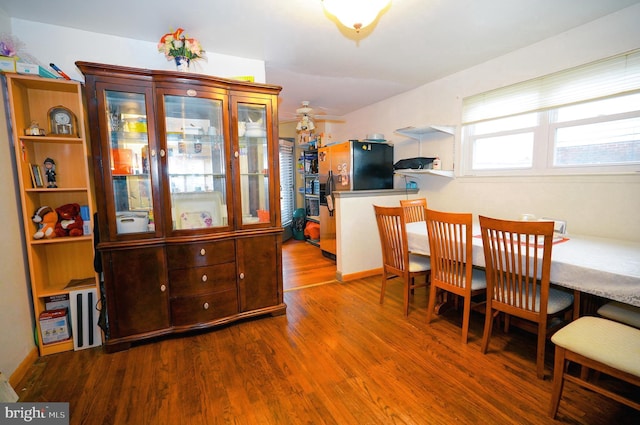 dining area with hardwood / wood-style floors and ceiling fan