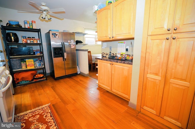 kitchen featuring light hardwood / wood-style floors, range, stainless steel refrigerator with ice dispenser, and light brown cabinets