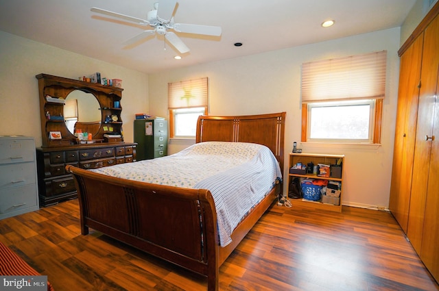 bedroom featuring ceiling fan, dark hardwood / wood-style flooring, and a closet