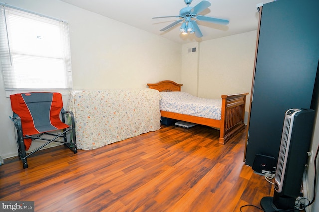 bedroom featuring dark hardwood / wood-style flooring and ceiling fan