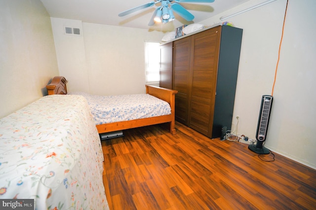 bedroom with ceiling fan, wood-type flooring, and a closet