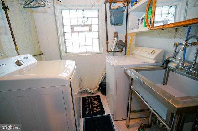 laundry area with washer and clothes dryer and sink