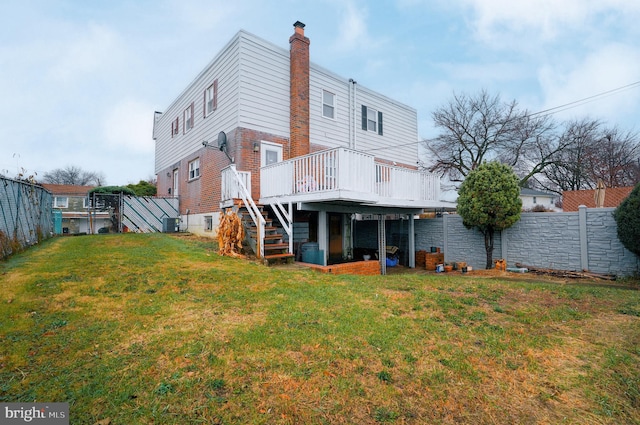 rear view of property featuring a yard, a wooden deck, and central air condition unit