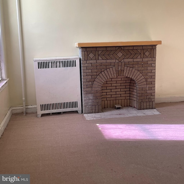 room details featuring a fireplace, carpet flooring, and heating unit