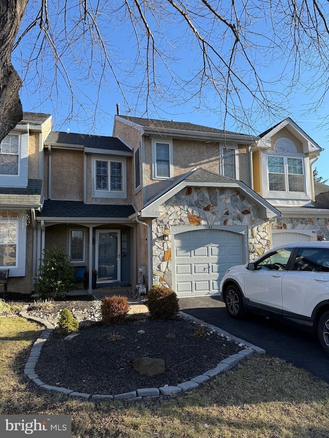 multi unit property featuring a garage