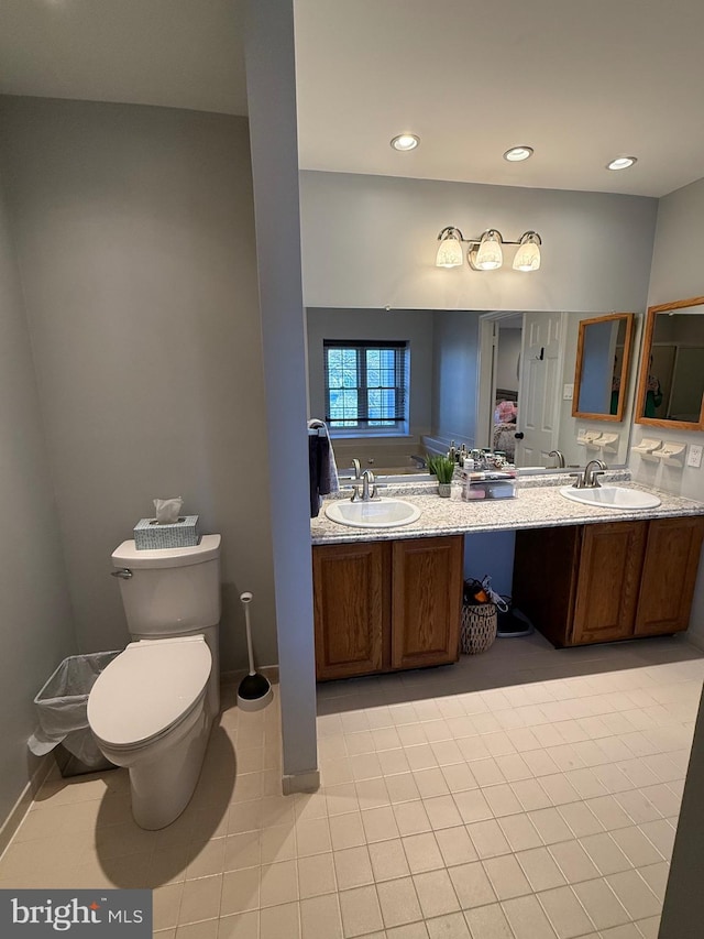 bathroom featuring tile patterned flooring, vanity, and toilet