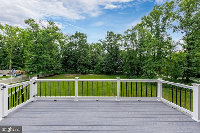 wooden terrace featuring a lawn