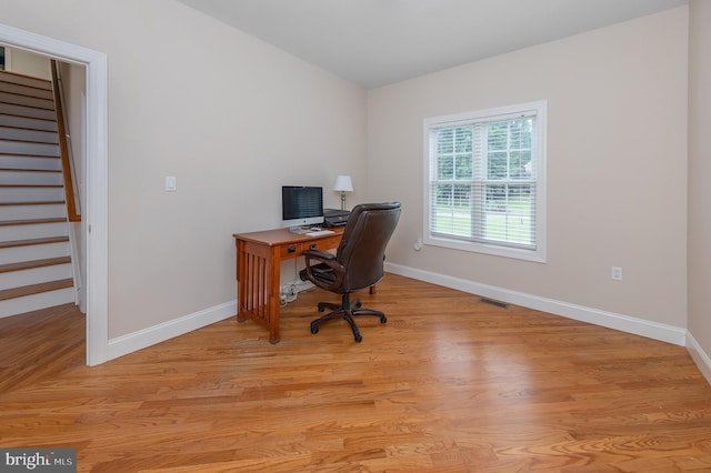 office with light hardwood / wood-style flooring