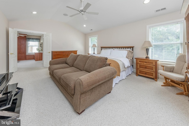 carpeted bedroom featuring ceiling fan, vaulted ceiling, and multiple windows