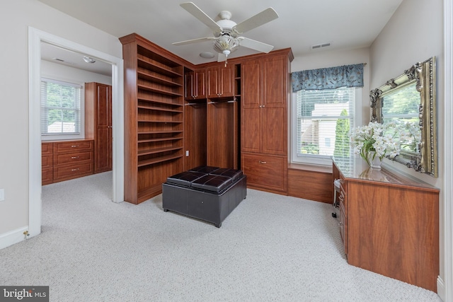 mudroom featuring ceiling fan, a healthy amount of sunlight, and light colored carpet