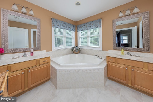 bathroom with vanity, tile patterned floors, and tiled tub