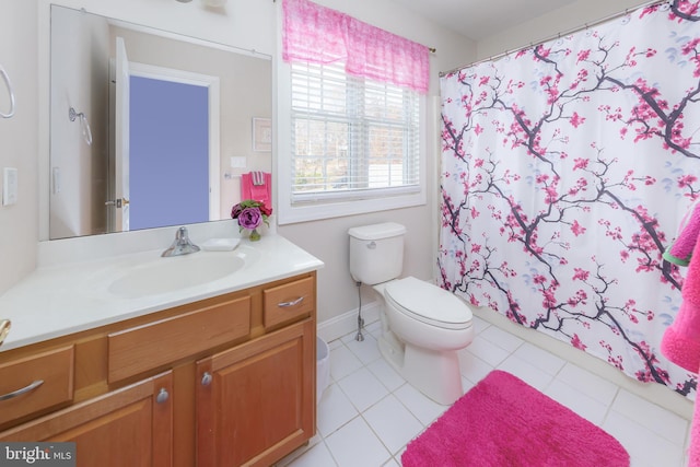 bathroom with tile patterned floors, vanity, toilet, and walk in shower