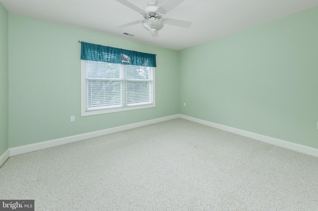 carpeted spare room with ceiling fan