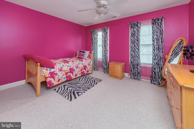 carpeted bedroom featuring ceiling fan and multiple windows