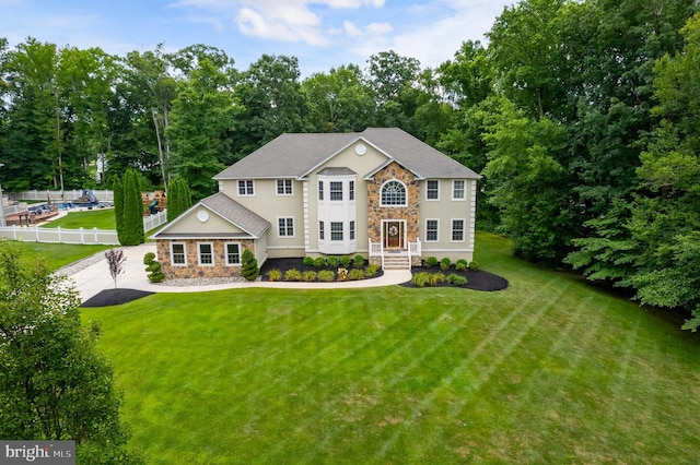 colonial inspired home featuring a front yard