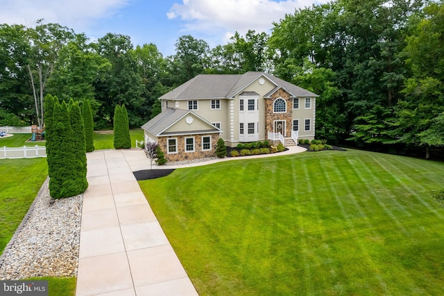 colonial home featuring a front lawn